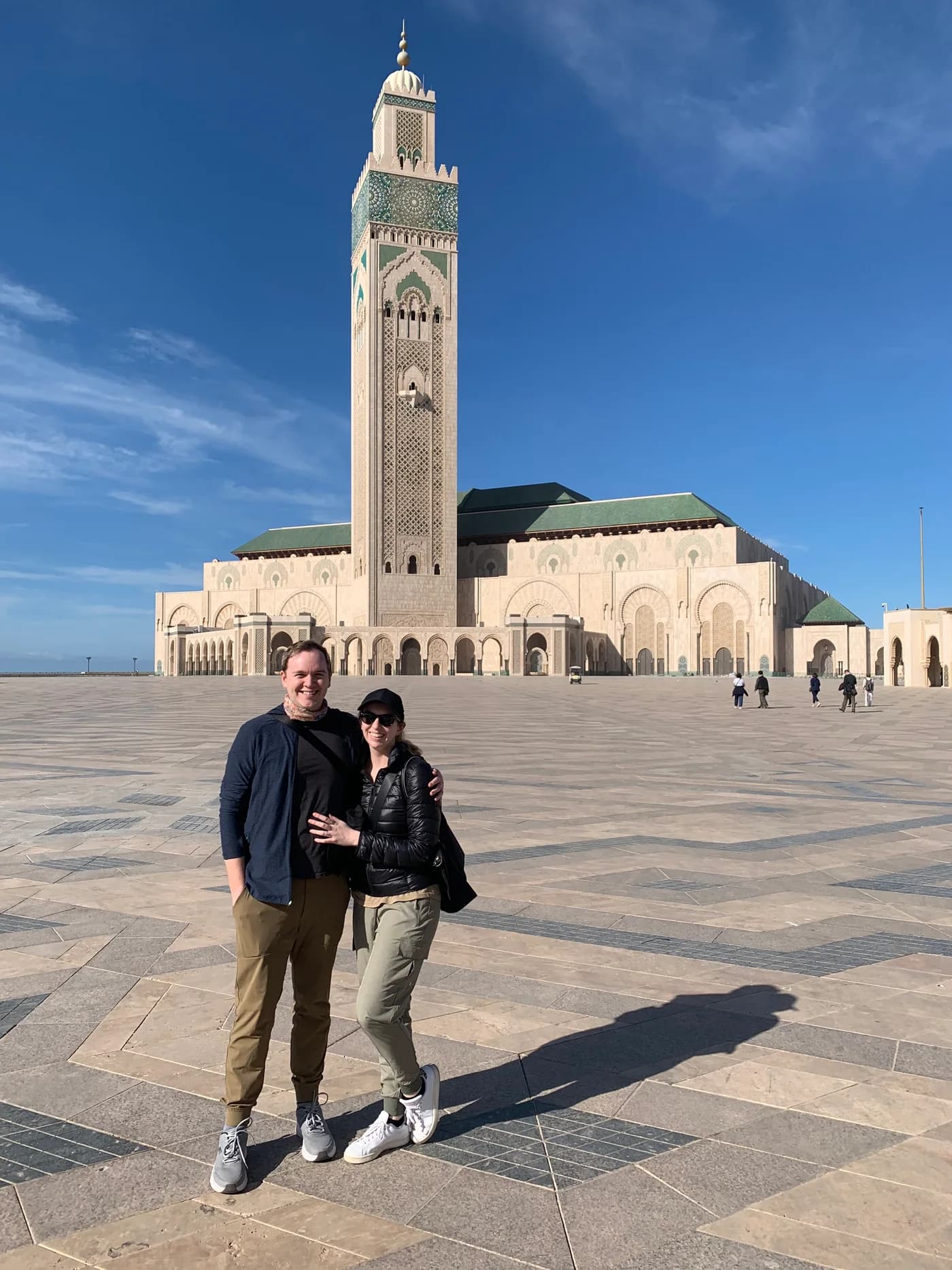 Jay and Gabi standing in front of Hassan II Mosque in Casablanca.